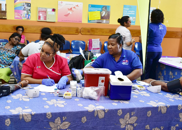 Members of the public having their screening for blood glucose, cholesterol and pressure.